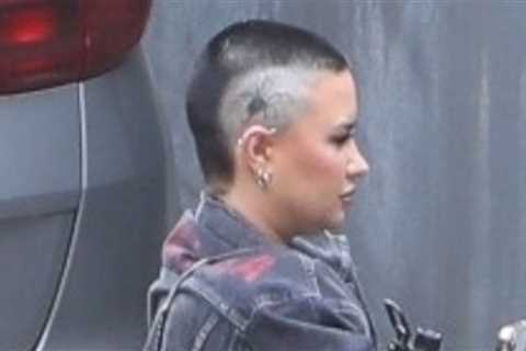 Demi Lovato shows off a new head tattoo upon arrival at the music studio