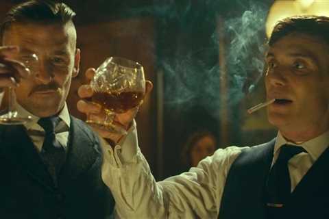 Why does Tommy Shelby lick his cigarette before smoking?