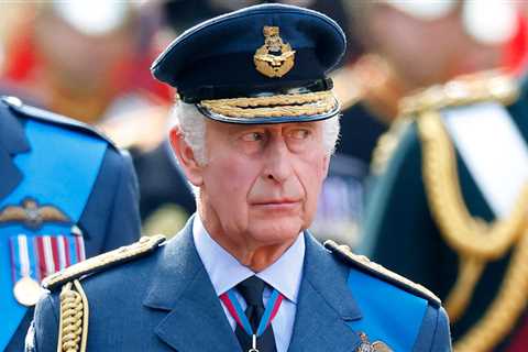 Why does King Charles wear a military uniform and what medals does he have?