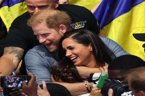 Meghan Markle and Prince Harry continue loved-up display as they hug each other among Invictus..