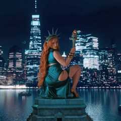 Ice Spice Transforms Into the Statue of Liberty for NYC-Themed ‘Oh Shhh…’ Video With Travis Scott