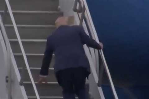 Donald Trump Trips Up The Steps Of Air Force One