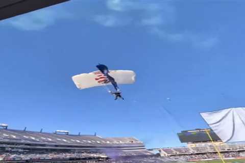 Shocking scene as parachuter caught in field goal netting at bowl game