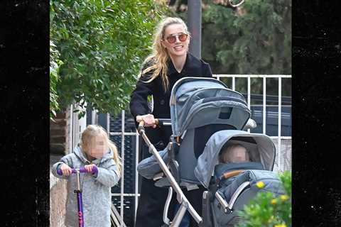 Amber Heard All Smiles as Johnny Depp Films Hollywood Return