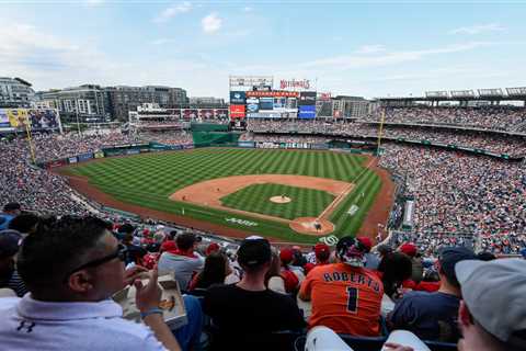 Nationals ban fan after holding white nationalist sign