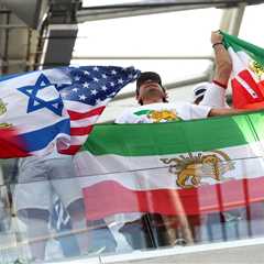 Iranian World Cup soccer fans wave pre-revolutionary flag inside stadium despite FIFA ban