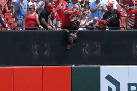 Reds fan holds kid by legs in effort to get home run ball in wild scene: ‘Going to sacrifice his..