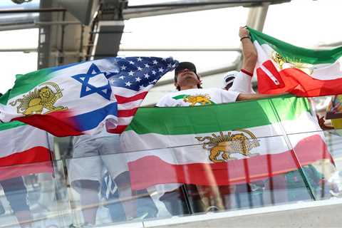 Iranian World Cup soccer fans wave pre-revolutionary flag inside stadium despite FIFA ban