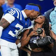 Simone Biles kisses husband Jonathan Owens on the field before Colts game