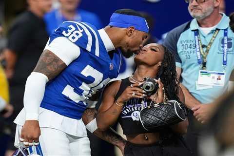 Simone Biles kisses husband Jonathan Owens on the field before Colts game